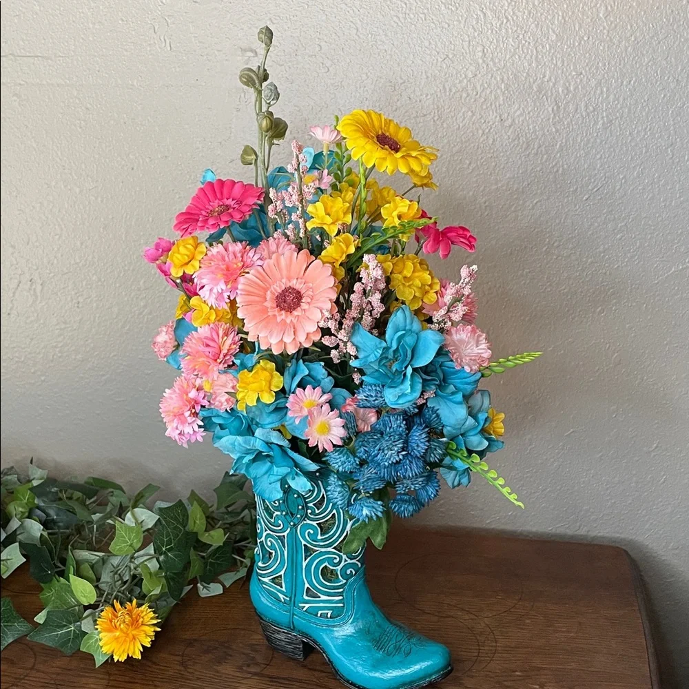 Cute colorful silk arrangement in a resin decorative boot. 🌺